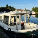 Jeanneau Eau Claire 930 river cruiser Cassis (1985) – starboard bow view moored on canal