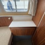 Locaboat 935 canal cruiser Kerplouf (1986) – storage cupboard and worktop beside the settee