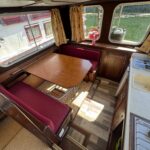 Locaboat 930 canal cruiser Sérénité (1981) – saloon and galley area with table and sink