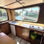 Locaboat 930 canal cruiser Sérénité (1981) – galley with sink, fridge and gas hob
