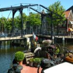 Dutch Hagenaar barge 18 m ANNA (1911) – exterior view moored by a Dutch drawbridge