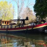 Dutch Hagenaar barge 18 m ANNA (1911) – port side exterior view moored under trees