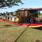 Dutch Hagenaar barge 18 m ANNA (1911) – starboard exterior view moored along a grassy bank