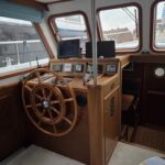 Bronsveen Kotter 1480 Dutch motor yacht Petit Michou (2002) – inside wheelhouse with spoked wheel