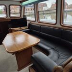 Bronsveen Kotter 1480 Dutch motor yacht Petit Michou (2002) – saloon with leather settee and table