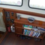 Dutch Luxe-Motor barge 14.50 m (1928) – bookcase and electrical panel in the wheelhouse