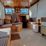 Dutch motor cruiser Helena Cruiser (1980) – saloon with wooden wheel and seating