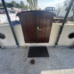 Dutch Tjalk sailing barge Osseo (1890) – wooden aft entrance door and portholes