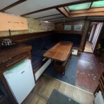 Dutch Tjalk sailing barge Osseo (1890) – saloon and galley area with refrigerator