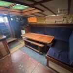 Dutch Tjalk sailing barge Osseo (1890) – saloon with table, settee and stairs