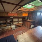 Dutch Tjalk sailing barge Osseo (1890) – saloon, skylight and storage shelving
