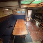 Dutch Tjalk sailing barge Osseo (1890) – saloon with bench seating and large table