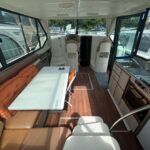 Nicols 1100 river cruiser Lodève (1998) – saloon table facing the galley