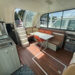 Nicols 1100 river cruiser Lodève (1998) – saloon with table, seating and galley corner