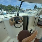 Nicols 1100 river cruiser Lodève (1998) – inside helm with wheel and instruments