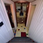 Dutch Luxe-Motor barge Dulcinea (1929) – stairs down to the colourful tiled hallway leading to the saloon