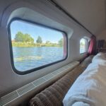 Dutch Luxe-Motor barge Dulcinea (1929) – river view from the saloon sofa through a large window