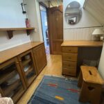 Dutch Luxe-Motor barge Dulcinea (1929) – cabin storage: glazed sideboard, wooden desk and stool