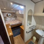 Dutch Luxe-Motor barge Dulcinea (1929) – forward cabin with double bed and washbasin
