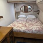 Dutch Luxe-Motor barge Dulcinea (1929) – cabin with double bed, mirror and brass porthole