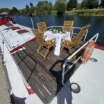 Dutch Luxe-Motor barge Dulcinea (1929) – wooden deck terrace with dining table and chairs