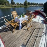 Dutch Luxe-Motor barge Dulcinea (1929) – dining area on the foredeck, table set facing the bow