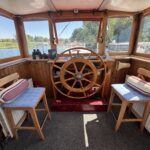 Dutch Luxe-Motor barge Dulcinea (1929) – wheelhouse interior with traditional wooden steering wheel