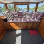 Dutch Luxe-Motor barge Dulcinea (1929) – bench seat with striped cushions in the glazed wheelhouse