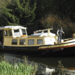 Dutch Luxe-Motor barge 14.50 m (1928) – cruising on a tree-lined canal
