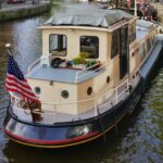 Dutch Luxe-Motor barge 14.50 m (1928) – exterior three-quarter bow view at the quay