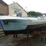 Residential barge 19.46 m (1905) – repainted hull in dry dock