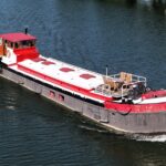Dutch Luxe-Motor barge Dulcinea (1929) – aerial bow-quarter view underway, terrace on the foredeck