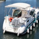 Nicols 1100 river cruiser Lodève (1998) – aerial starboard-quarter view on the water