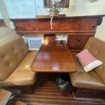 Schouten Muiden trawler Tibo (1978) – saloon with leather dinette and table