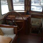 Dutch Luxe-Motor barge 14.50 m (1928) – wheelhouse with ship's wheel and stairs to the saloon