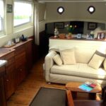 Dutch Luxe-Motor barge 14.50 m (1928) – bright saloon with sofa and walnut joinery