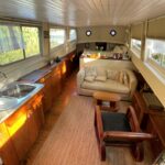 Dutch Luxe-Motor barge 14.50 m (1928) – saloon with sofa, armchair and open galley